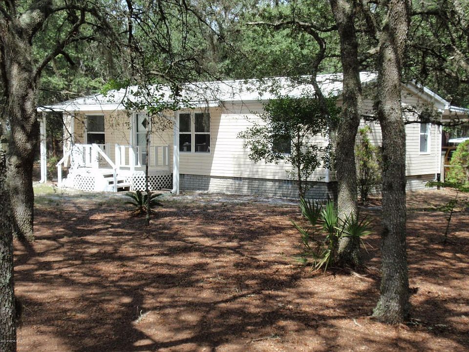 Home surrounded by mature oaks trees
