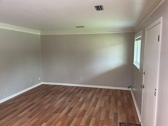 Living room from kitchen. Crown molding, Laminate flooring, FRESH paint.