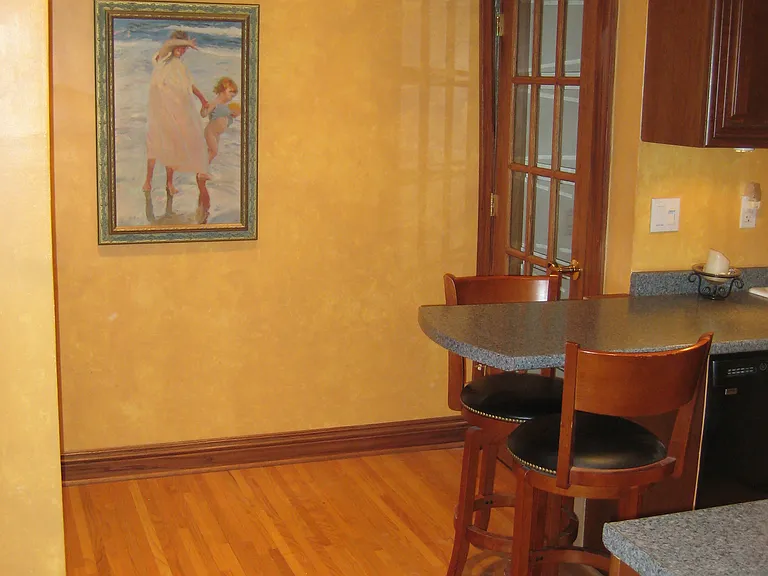 Looking northeast kitchen and door to basement and east side to shared outside door. Kitchen door has a deadbolt lock.