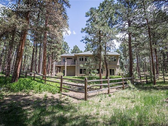 Stone paved front walk with covered grand entrance.