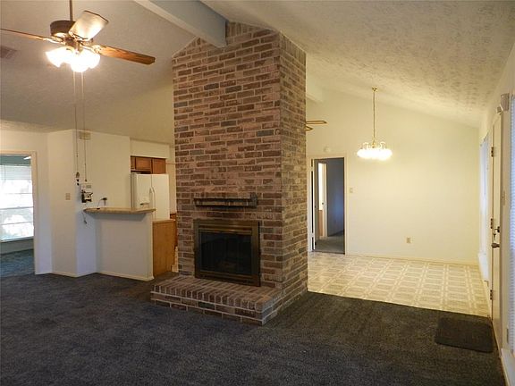 Open floor plan with a wood burning fireplace in family room.