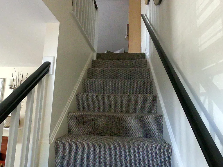 Stairs leading up to media room/living room.