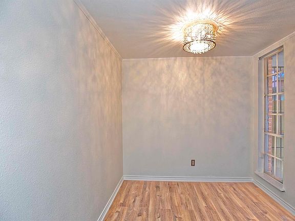 10x10 Dining Room - Cozy dining with shadows playing across the walls and ceiling from the ceiling mounted fixture. Natural light from the window will brighten your days.