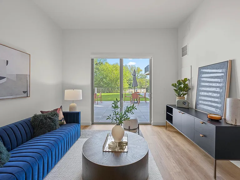 Spacious living room with access to outdoor patio.