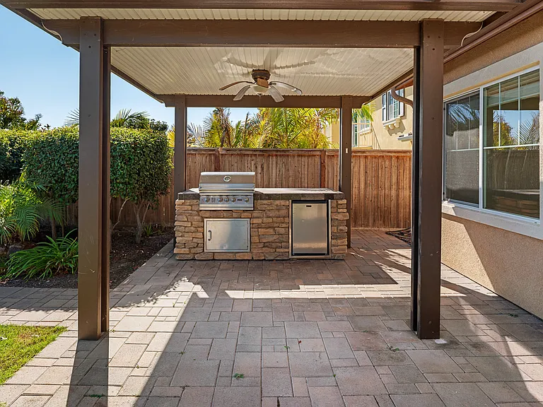 Backyard Gazebo with Fan, Built-in BBQ and Refrigerator.