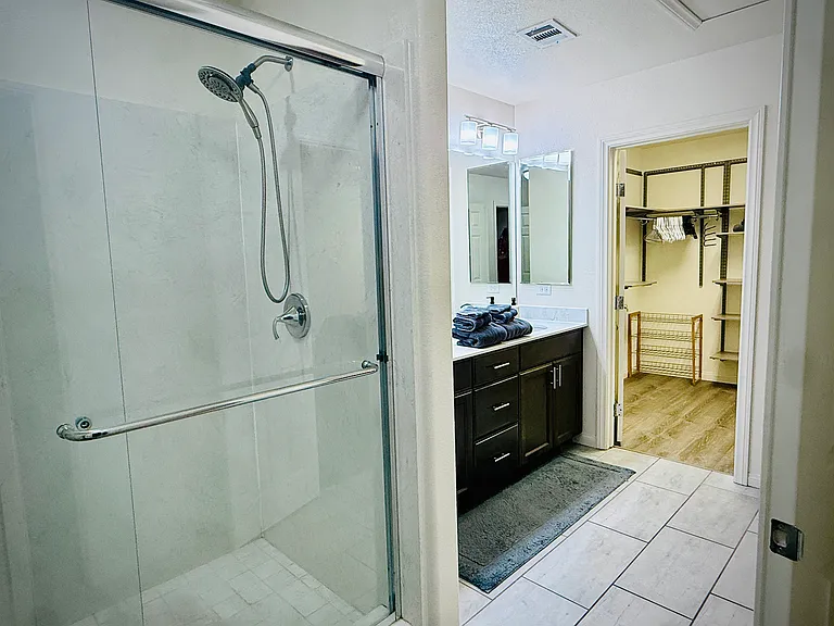 Master standing shower, dual sinks, and oversized walk-in closet.