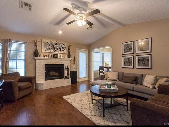 Large and open living room with wood burning fireplace