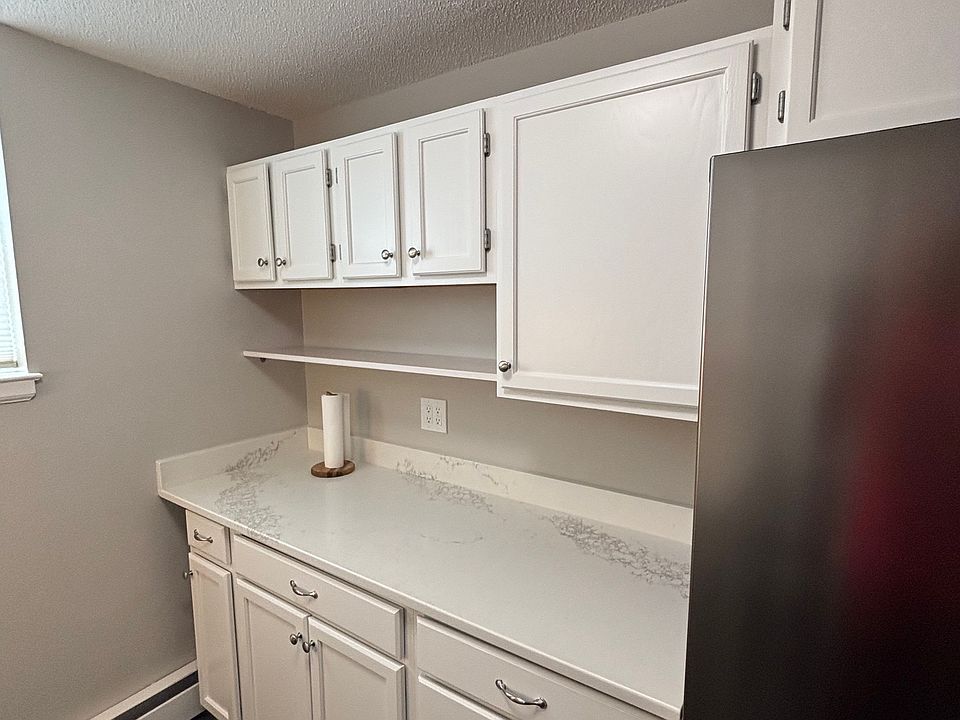 Kitchen with white quartz countertop.