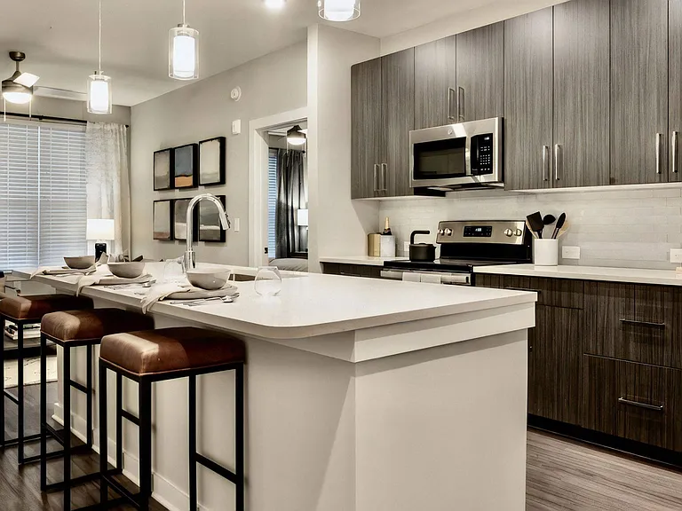 Kitchen with Island Seating, Dining Area, and Stainless Steel Appliances