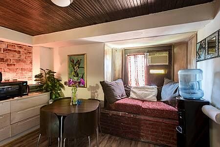 View of front room with kitchenette -& front window couch cubby great for relaxing or reading a book with view of nice front yard area that has bbq w/table chairs & benches