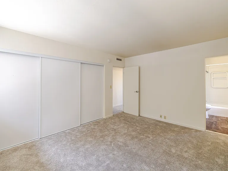 Bedroom B offers a spacious layout with seamless access to the hallway and bath.