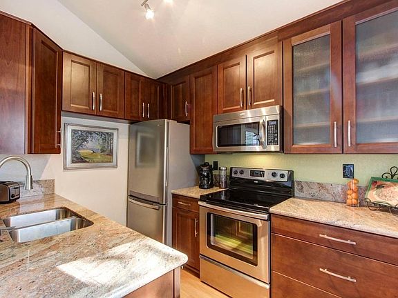 Kitchen includes stainless steel refrigerator, microwave, range and dishwasher