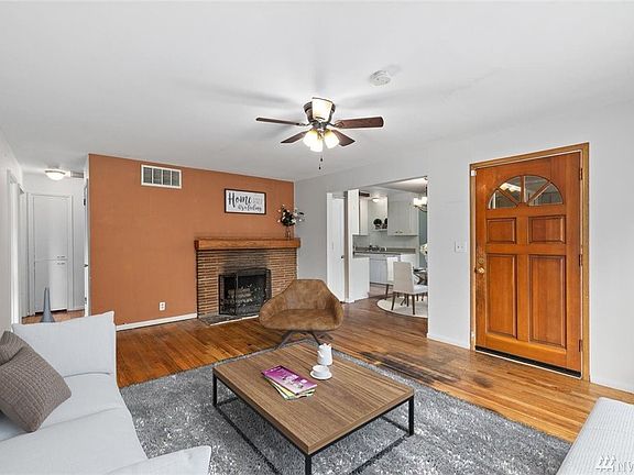 Large living room with wood burning fireplace.