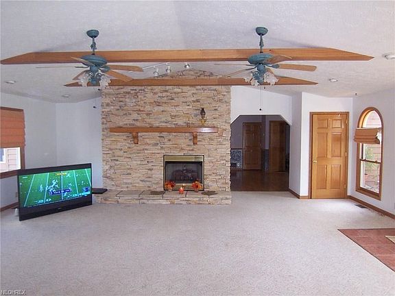 The cathedral ceilings and exposed beams make the room feel even larger than it is.