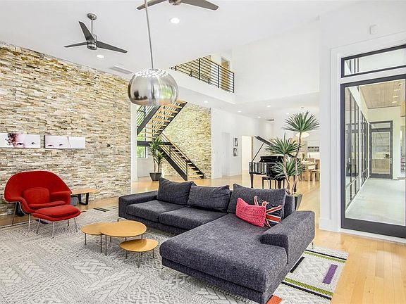 Stone stacked walls inside and out with an amazing floating staircase and Maple wood flooring throughout first level.