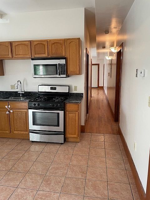 Part of the kitchen area and walking hallway into the living room