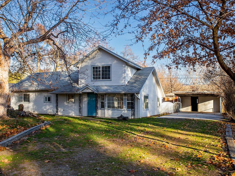 Front of the property, driveway and carport.