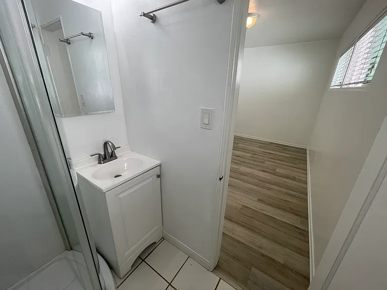Vanity with view into bedroom.