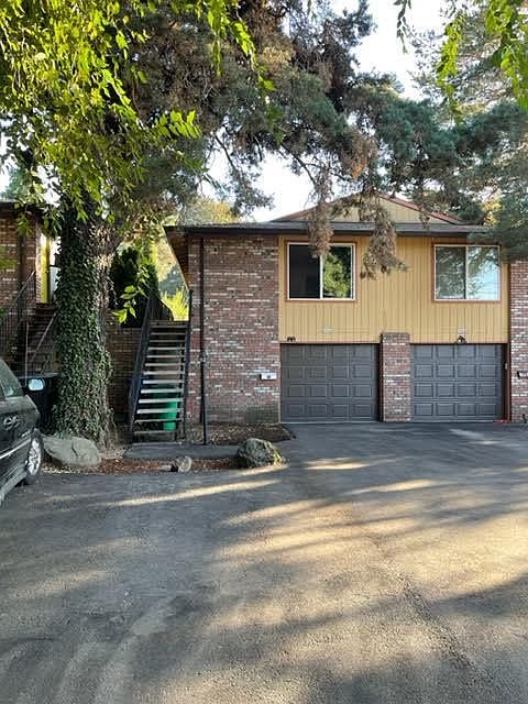 The street sides of this property are surrounded by large trees.There is a large garage with automatic garage door plus parking for two cars on the driveway.