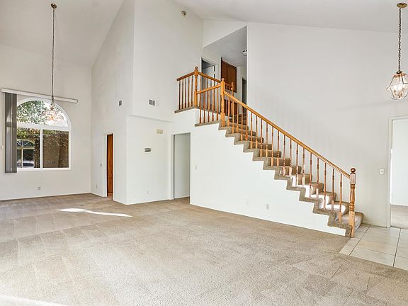 ENTRY, LIVING ROOM FAMILY ROOM HAS MAJESTIC VAULTED CEILINGS AND BEAUTIFUL STAIR CASE.