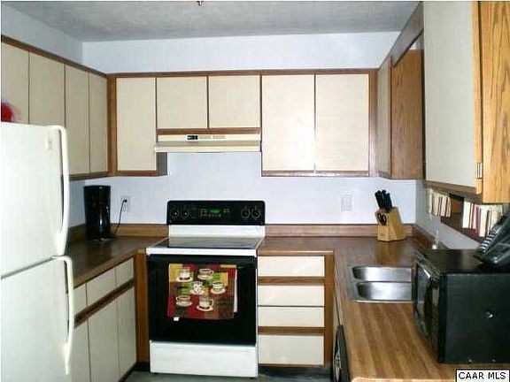 Full view of the kitchen, wood cabinets, formica counters