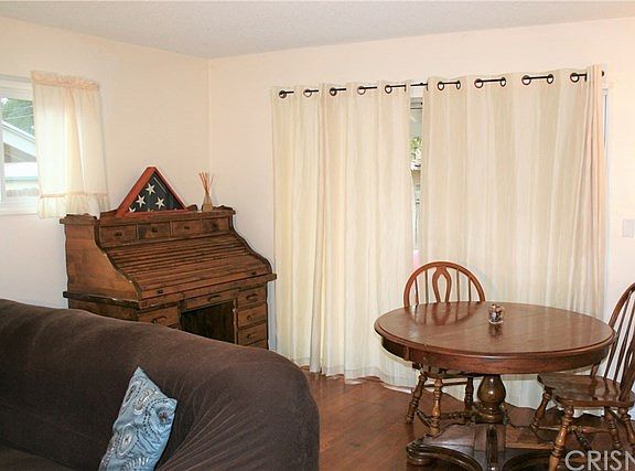 Formal dining area with slider leading to back patio