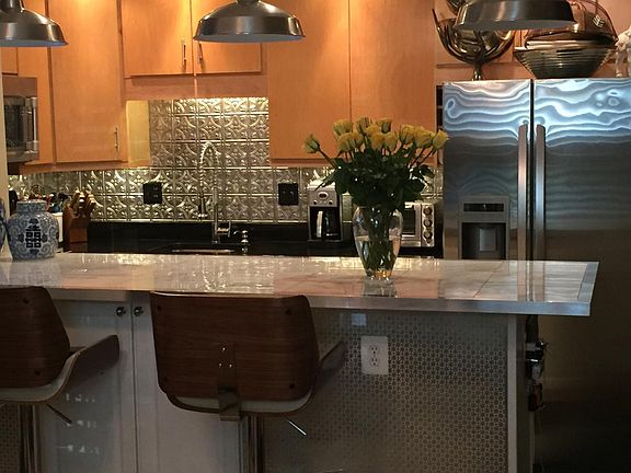 Huge kitchen peninsula for entertaining and pressed tin backsplash.