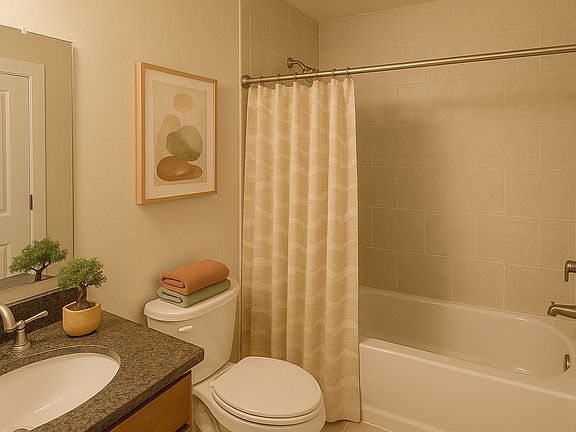 The bathroom has everything you need with a tiled bath and shower, counter with space to get ready for or end your day, and additional storage right outside with a linen closet.