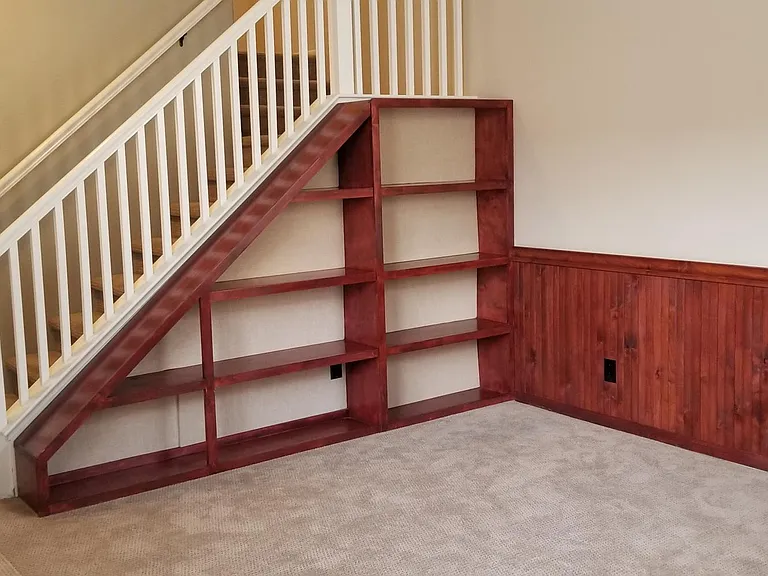 Formal Entry with custom wainscoting on the walls and custom book shelves with linen lined backings