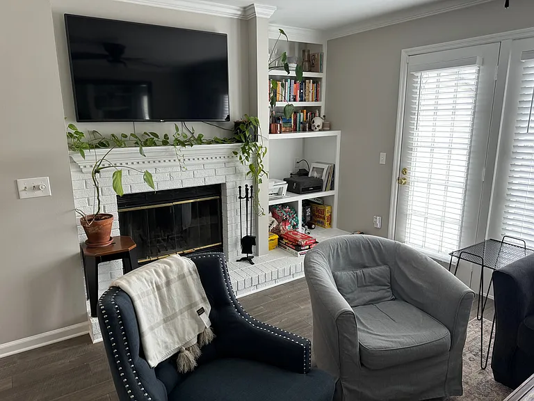Den with fireplace and door to patio
