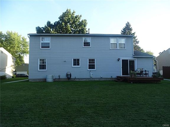 Back yard is flat and almost fully fenced-in with a small back deck.