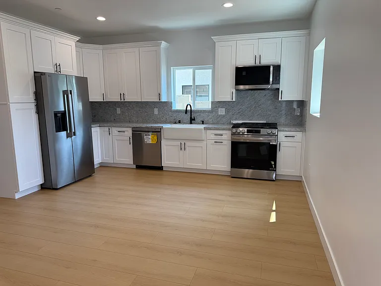 Kitchen 1/2 of front room. Plenty of counters and full appliances. Fridge/freezer and water/ice maker, dishwasher, insinkerator, gas range/air fryer, & microwave/hood.