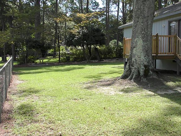fenced-in backyard with deck