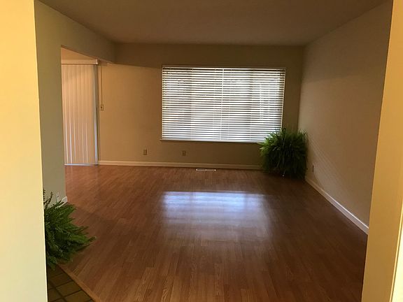 Family Room with 2 inch Wood Blinds, facing back patio. Measures 12ft. x 16ft.