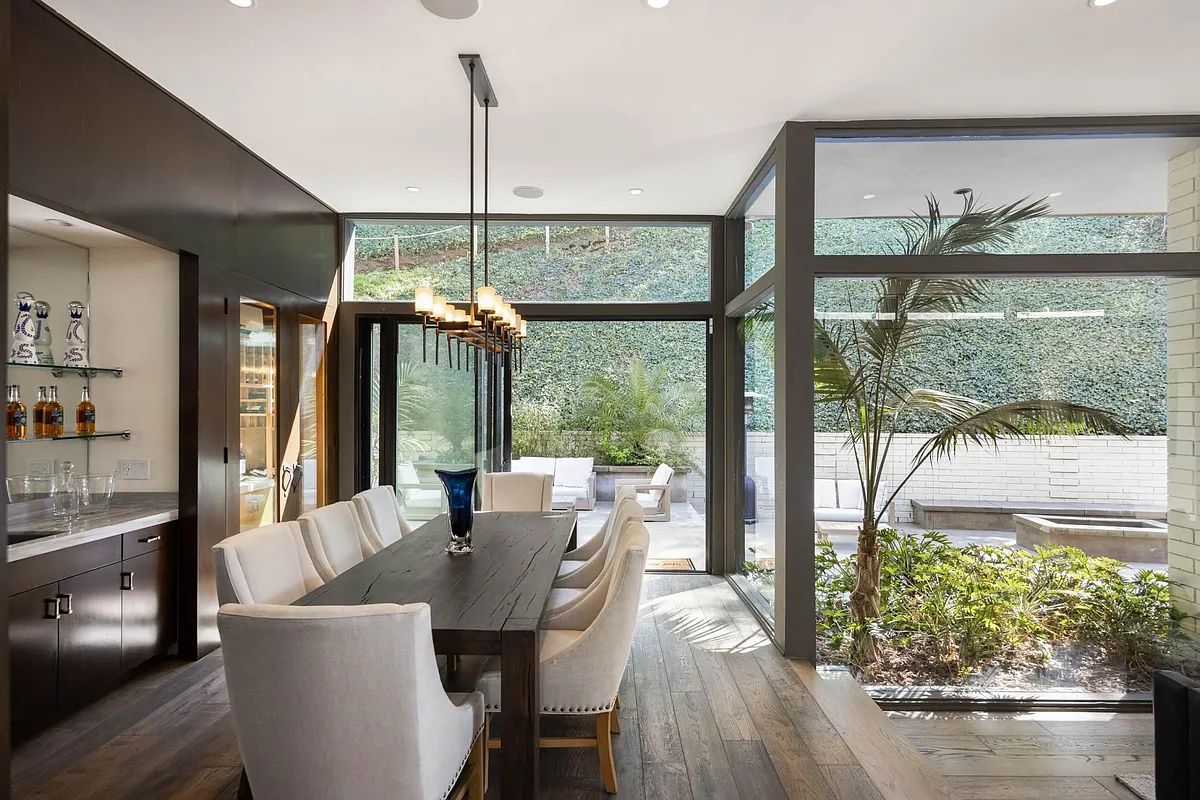 Indulge in gourmet delights in the dining room, equipped with sleek countertops and elegant seating. - 9466 Cherokee Ln