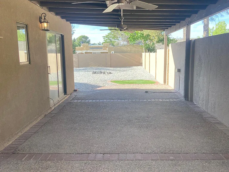 large covered patio with outdoor ceiling fans