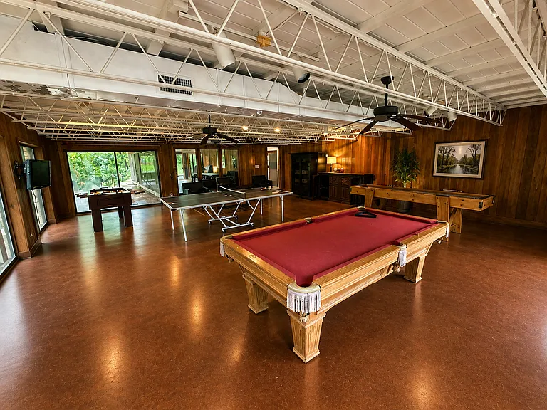 Game room with pool table, ping pong, shuffle board, and foosball table