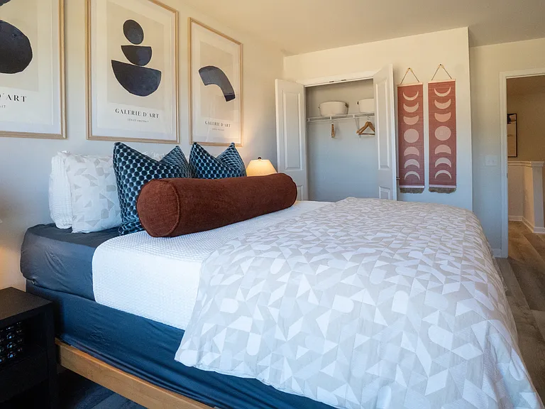 Secondary bedroom on the second floor with natural light and closet with french doors.