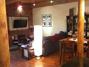 Dining/living room with exposed brick and timber