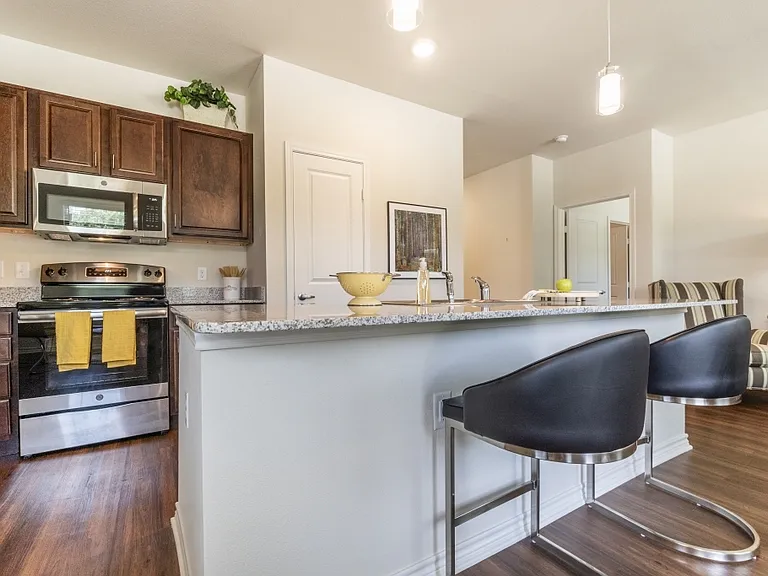 Stylish kitchens with granite countertops and bar seating in our Tyler apartment homes.
