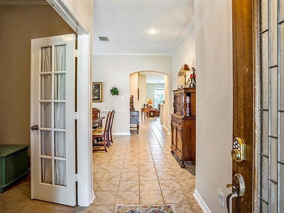As you enter the home you notice tiled floors throughout the living area and French doors to the study.