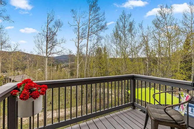 Back deck off of main level, with hot tub and outdoor furniture