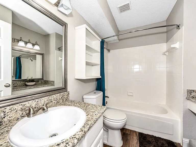 Clean, bright bathroom with full tub/shower combo and updated vanity.