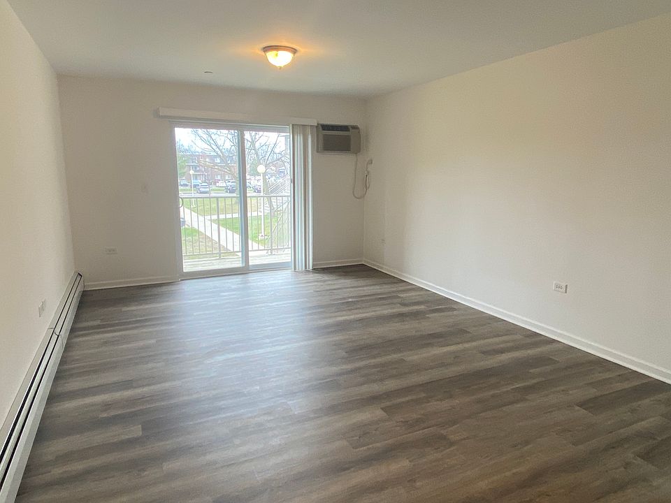Large living room with AC controls and slider to balcony