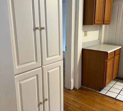 Kitchen pantry and cupboards off of living room