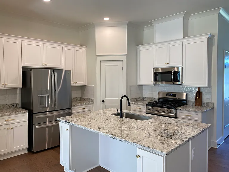 Kitchen with new gold hardware on kitchen cabinets.