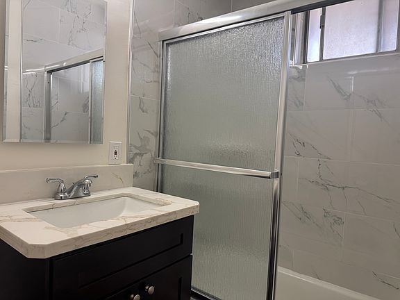 Newly remodeled bathroom: new flooring, new bathroom vanity, new tub, new toilet