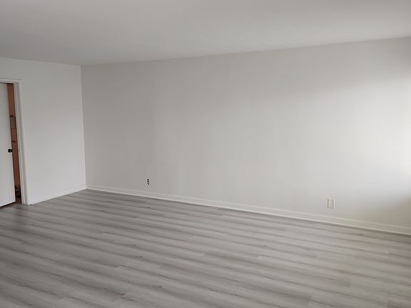 Large light and bright living room with new floors and paint