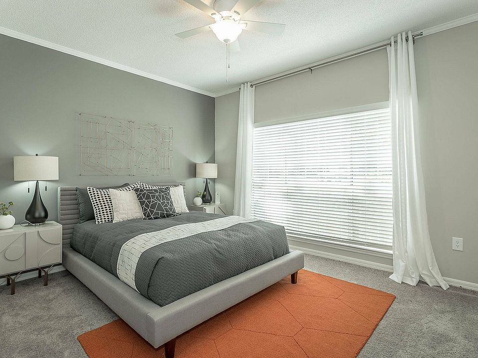 Experience comfort and style in this spacious bedroom at Avenues of Kennesaw in Kennesaw, GA.