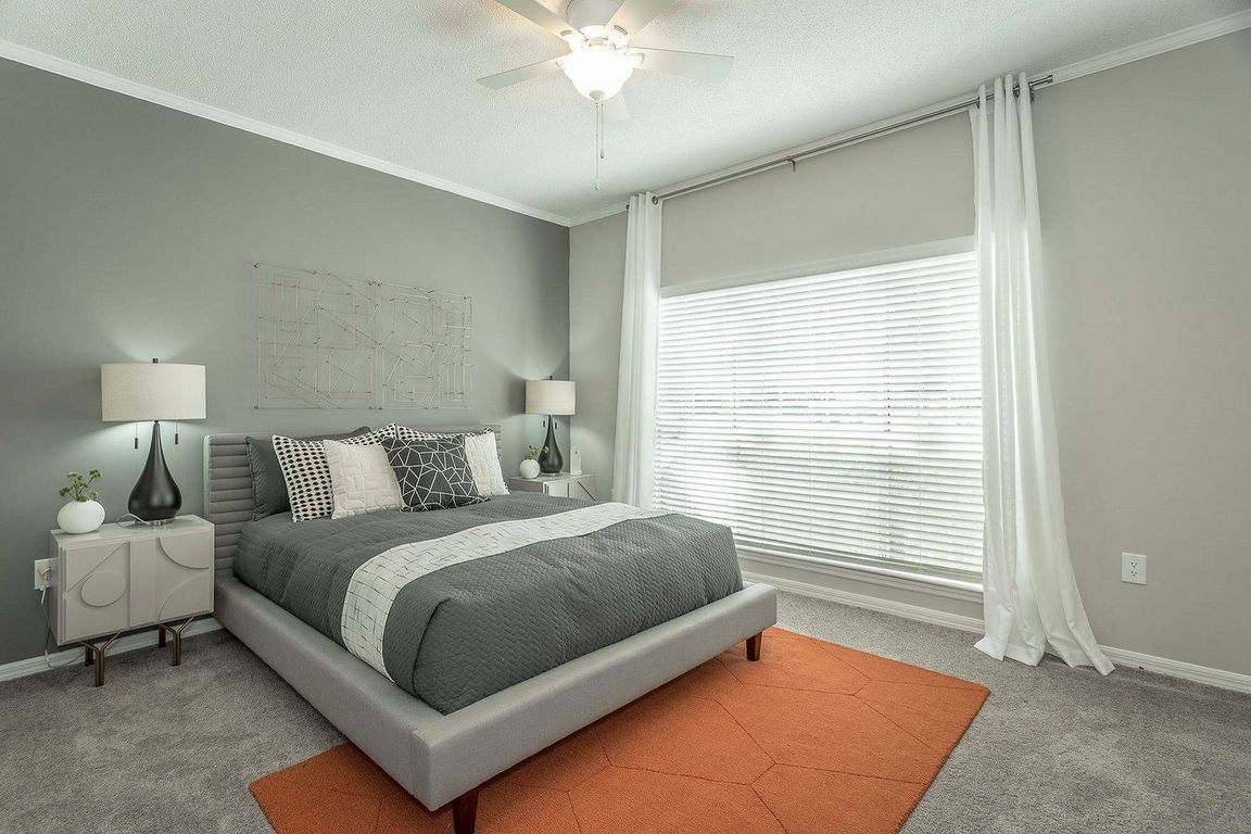 Experience comfort and style in this spacious bedroom at Avenues of Kennesaw in Kennesaw, GA.